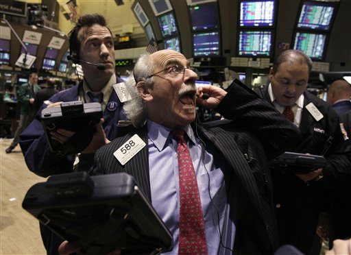 Trader Peter Tuchman, center, works on the floor of the New York Stock Exchange. The Dow Jones industrial average made big gains Monday, rising 162 points. (AP Photo/Richard Drew)
