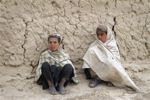 Afghan boys sit on the ground near the scene where Afghans were allegedly killed by a U.S. soldier in Panjwai, Kandahar Province.