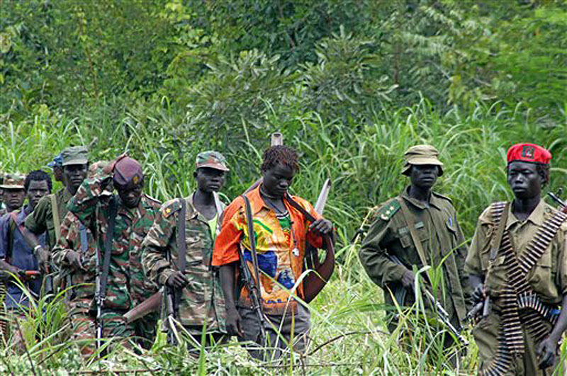 In this July 2006 photo, members of Uganda's Lord's Resistance Army are seen as their leader Joseph Kony meets with a delegation of Ugandan officials and lawmakers and representatives from non-governmental organizations, in the Democratic Republic of Congo near the Sudanese border. A video by the advocacy group Invisible Children about the atrocities carried out by jungle militia leader Joseph Kony's Lord's Resistance Army is rocketing into viral video territory and is racking up millions of page views seemingly by the hour. (AP Photo, File)