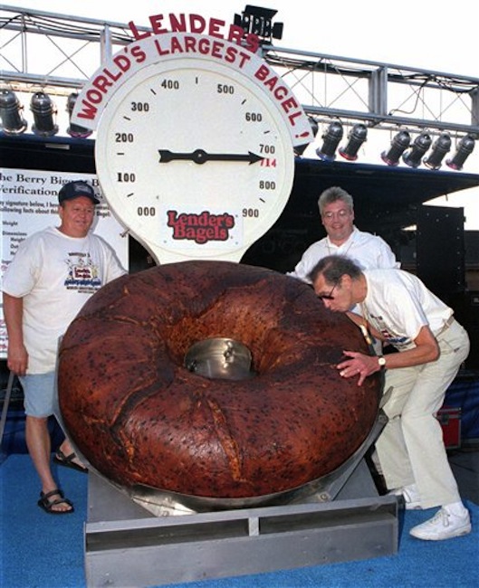 In this July 24, 1998 photo, Murray Lender kisses the world's largest bagel while baker Larry Wilkerson, left, and Lender's Bagel Bakery manager Jim Cudahy watch after the weight of the bagel was revealed during Bagelfest in Mattoon, Ill. Murray Lender, who helped turn his father's small Connecticut bakery into a national company that introduced bagels to many Americans for the first time, has died in Florida. He was 81. (AP Photo/Journal Gazette, Doug Lawhead)