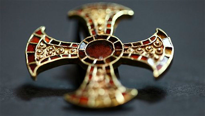 In this undated image made available by the University of Cambridge in England early Friday March 16, 2012, shows a cross. Archaeologists excavating near Cambridge have stumbled upon a rare and mysterious find: the skeleton of a 7th-Century teenager buried in an ornamental bed along with a gold-and-garnet cross, an iron knife and a purse of glass beads. (AP Photo/University of Cambridge)