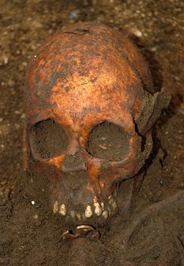 In this undated image made available by the University of Cambridge in England early Friday, March 16, 2012, showing a buried skull. Archaeologists excavating near Cambridge have stumbled upon a rare and mysterious find,: The skeleton of a 7th-Century teenager buried in bed, which may provide insight into a little-known funerary practice involving pagans and Christianity. (AP Photo/University of Cambridge)