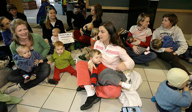In this Nov. 15, 2006 photo, Jesse Mongeon, center, holds her son Trey, with other protestors at a "nurse-in" at Burlington International Airport in South Burlington, Vt. to protest after a woman who was asked to leave an airplane in Vermont for breast-feeding her child. (AP Photo/Toby Talbot)