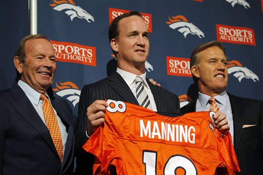 From left, Denver Broncos owner Pat Bowlen, newly-signed quarterback Peyton Manning and executive vice president of football operations John Elway pose for photos during a news conference at the team's headquarters in Englewood, Colo., today.