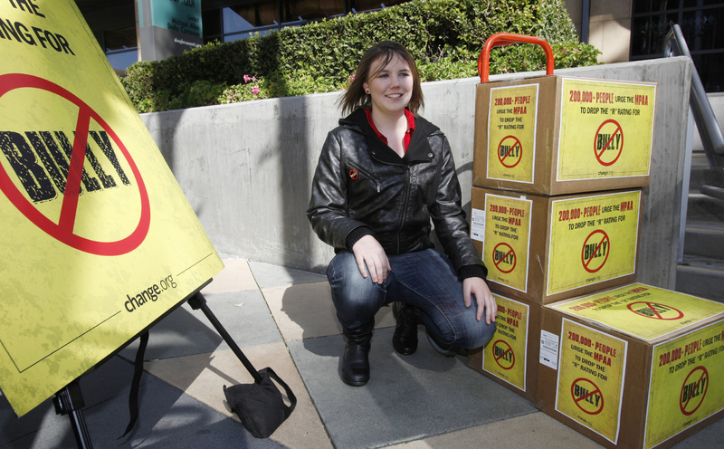 Katy Butler, 17, a high school student from Ann Arbor, Mich., poses by the petitions she delivered to the Motion Picture Association of America in Los Angeles on Wednesday. Butler is urging the MPAA to change the "R" rating to a "PG" for the "Bully" film.