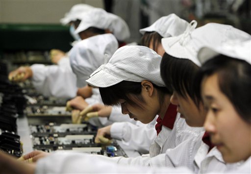 In this 2010 photo, staff members work on the production line at the Foxconn complex in Shenzhen, in southern China.
