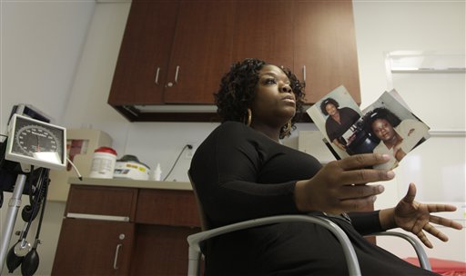 ITamikka McCray, 39, holds photos showing her before weigh-loss surgery, during an interview at Weill Cornell Medical Center in New York recently.