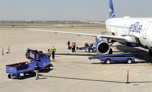 Officials remove baggage from JetBlue flight 191 and begin searching for explosives at Amarillo Rick Husband International Airport in Amarillo, Texas, Tuesday, March 27, 2012 after an unruly pilot caused the flight to make an emergency landing. (AP Photo/The Amarillo Globe News, Michael Schumacher)