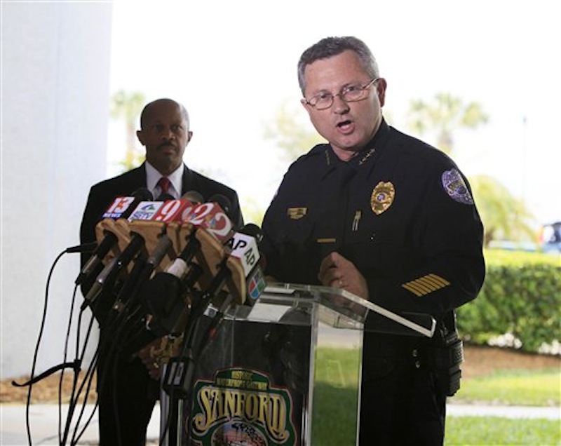 Sanford Police Chief Bill Lee speaks to the the media during a news conference Thursday, March 22, 2012 as city manager Norton Bonaparte Jr. listens at left, in Sanford, Fla. Lee, who has been bitterly criticized for not arresting a neighborhood watch volunteer in the shooting death of an unarmed black teenager, announced that he is temporarily stepping down to let passions cool. (AP Photo/Julie Fletcher)