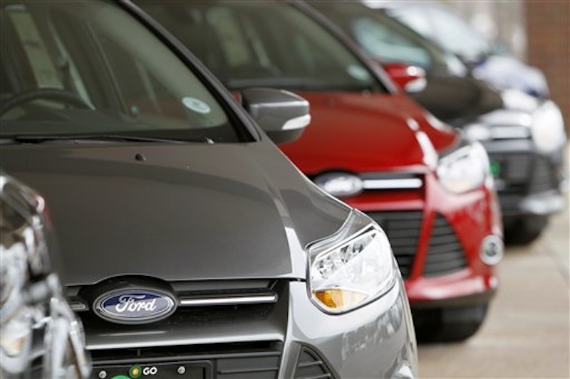 This Feb. 19, 2012 photo shows a line of 2012 Focus sedans at a Ford dealership in the south Denver suburb of Littleton, Colo. Ford Motor Co. said Thursday, March 1, 2012, its U.S. sales rose 14 percent in February thanks to big demand for its Focus compact car. (AP Photo/David Zalubowski)