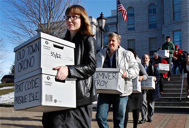 In this Thursday, Jan. 26, 2012 photo, Whitney Gifford, of Bucksport, Maine, leads a group of gay marriage supporters carrying signed petitions to the Secretary of State's office in Augusta, Maine. The Defense of Marriage Act, prevents gay married couples from receiving marriage benefits, is heading to a federal appeals court in Massachusetts. (AP Photo/Robert F. Bukaty)