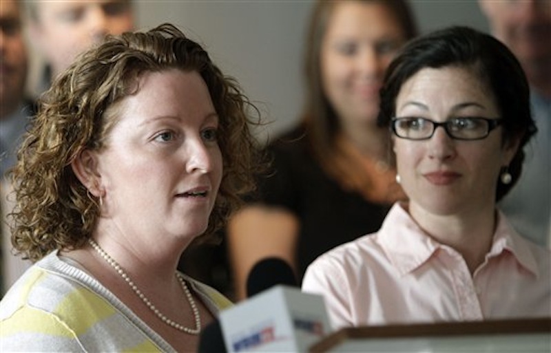 Emily French-Dumont, right listens as her partner Mary Dumont talks against a bill to repeal the law allowing same-sex marriage during a news conference on Monday, March 19, 2012 in Concord, N.H. The House votes later this week on a bill to repeal the law allowing same-sex marriages. (AP Photo/Jim Cole)