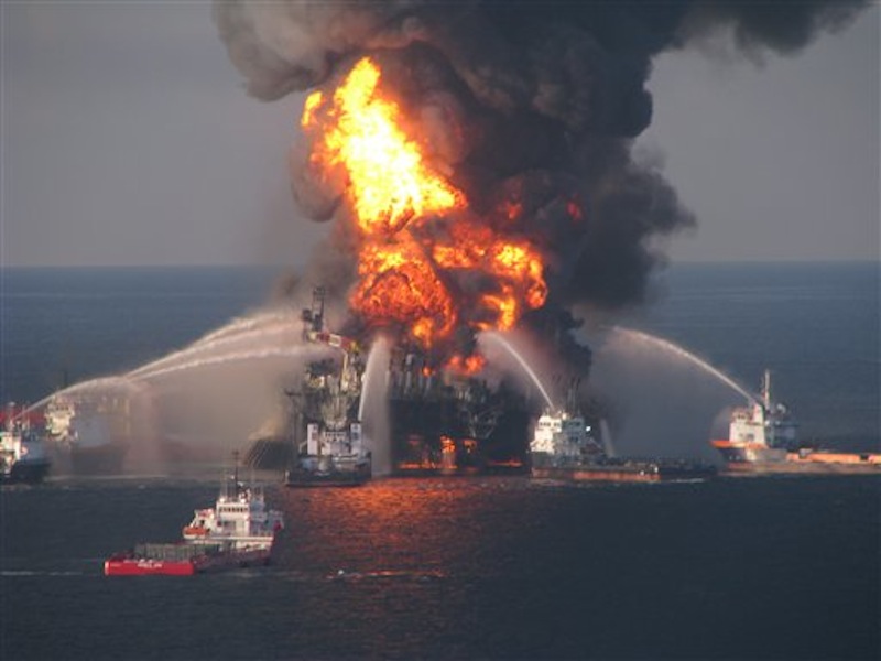 In this April 21, 2010 photo provided by the U.S. Coast Guard, fire boat response crews spray water on the blazing remnants of BP's Deepwater Horizon offshore oil rig. (AP Photo/US Coast Guard, File)