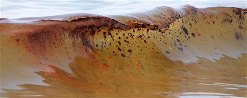 In this June 2010 photo, crude oil from the Deepwater Horizon oil spill washes ashore in Orange Beach, Ala. BP agreed late Friday March 2, 2012 to settle lawsuits brought by more than 100,000 fishermen who lost work, cleanup workers who got sick and others who claimed harm from the oil giant's 2010 Gulf of Mexico disaster, the worst offshore oil spill in the nation's history. The momentous settlement will have no cap to compensate the plaintiffs, though BP PLC estimated it would have to pay out about $7.8 billion, making it one of the largest class-action settlements ever. (AP Photo/Dave Martin, File)