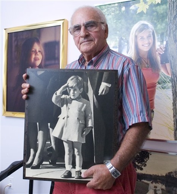 In this Sept. 7, 2007 photo taken in Annapolis, Md., former UPI photographer Stan Stearns holds his photo of John F. Kennedy Jr. saluting his father's coffin. Stearns died Friday, March 2, 2012, of cancer at a hospice in Harwood, Md., said his son Jay Stearns. He was 76. (AP Photo/The Capital, Joshua McKerrow)