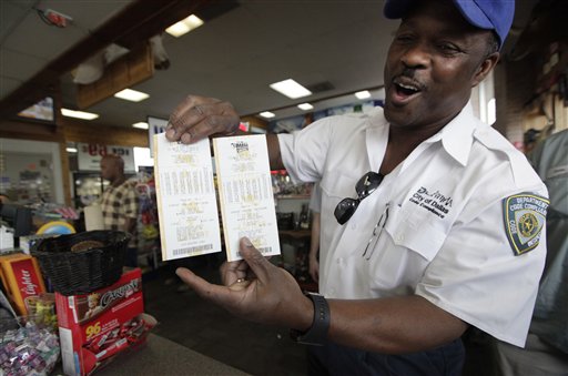 City of Dallas code inspector Frank Forshee shows off his Mega Millions lottery tickets he bought during his lunch break at the Fuel City store Friday, March 30, 2012 in Dallas. (AP Photo/LM Otero)