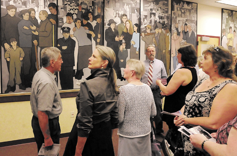 This file photo shows people looking at Judy Taylor’s mural depicting the history of Maine labor while it was on display in the Department of Labor lobby in Augusta, prior to Gov. Paul LePage’s order to have it removed.