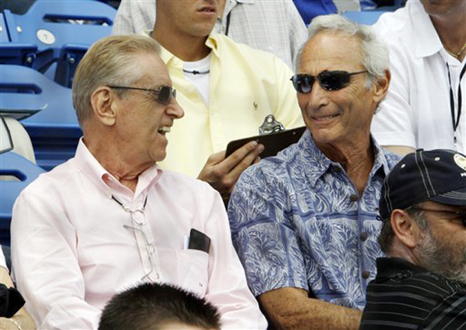 In this March 2009 photo, New York Mets owner Fred Wilpon, left, and his childhood friend, Hall of Fame pitcher Sandy Koufax, sit together during a spring training game in Port St. Lucie, Fla. Koufax, who invested with financier Bernard Madoff at Wilpon's urging, had been expected to testify on behalf of Wilpon before the settlement was announced.