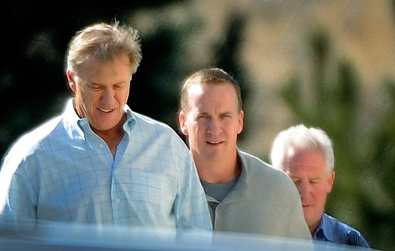 NFL quarterback Peyton Manning, center, takes a tour with executive vice president of football operations for the Denver Broncos John Elway, left, and Broncos coach John Fox at the Broncos' training facility in Englewood, Colo. on Friday, March 9, 2012. Four-time MVP Manning opened his free-agency tour of NFL suitors Friday. (AP Photo/The Denver Post, John Leyba)
