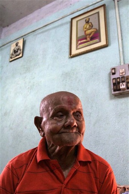 Indian body builder Manohar Aich looks on at his residence in Kolkata, India on Sunday, March 18, 2012. Aich, who is only 4 foot 11 inches (150 centimeters) tall, won the Mr. Universe title in London way back in 1952. Happiness and a life without tensions are the key to his longevity, said Aich, who turned 100 on March 17. (AP Photo/Bikas Das)