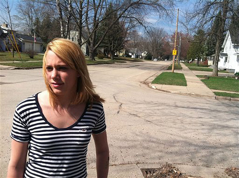 Jordan Pfeiler talks about the mystery booms she's heard over the past few days as she stands outside her house Wednesday, March 21, 2012, in Clintonville, Wis. City officials are trying to record the mysterious booming sounds that have roused residents from their beds, sometimes still in pajamas, but their attempts have so far come up empty. (AP Photo/Carrie Antlfinger)