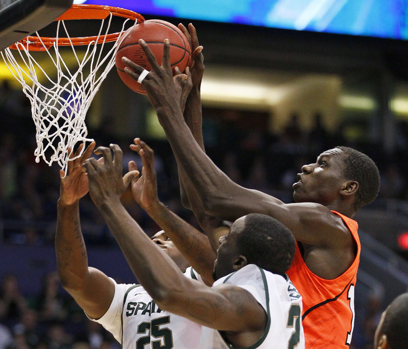 Michigan State's Derrick Nix, left, and Draymond Green, lower right, vie for possession of the ball with Louisville's Gorgui Dieng in the NCAA West Regional semifinal on Thursday.