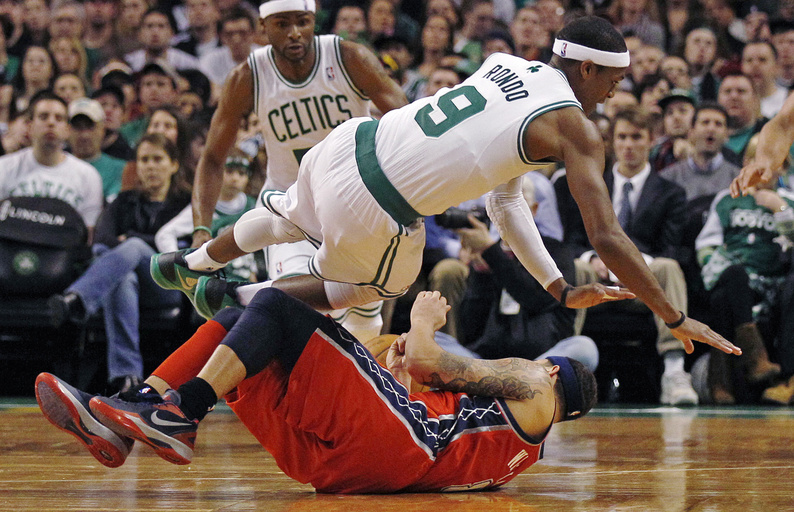 Celtics guard Rajon Rondo collides with Nets guard Deron Williams during Friday night's game in Boston. The Celtics won, 107-94.