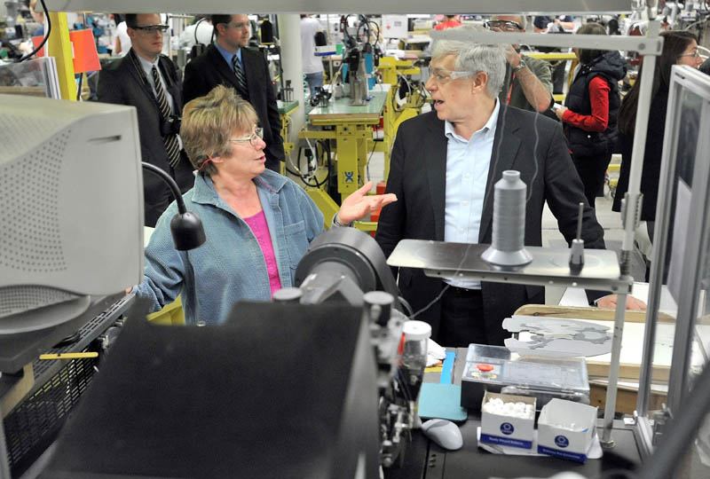 Rep. Mike Michaud speaks to New Balance factory employee Rose Bailey during a tour of the New Balance shoe factory in Norridgewock today.