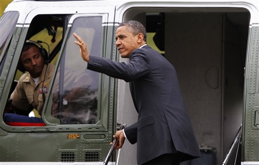 President Barack Obama waves as he boards the Marine One helicopter on the South Lawn of the White House today to begin his trip to Vermont and Maine for campaign fundraising events.