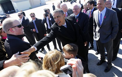 President Barack Obama, accompanied by Sen. Bernard Sanders, I-Vt., and Vermont Gov. Peter Shumlin, greets supporters on the tarmac upon his arrival at Burlington Air National Guard Base today.