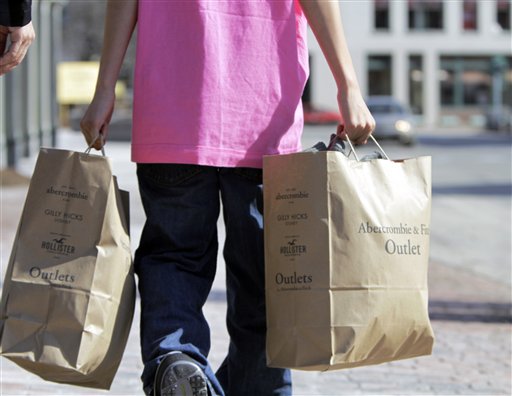 A shopper carries bags of merchandise in Freeport on Monday. February retail sales rose 1.1 percent, the biggest gain in five months, with autos showing strength.