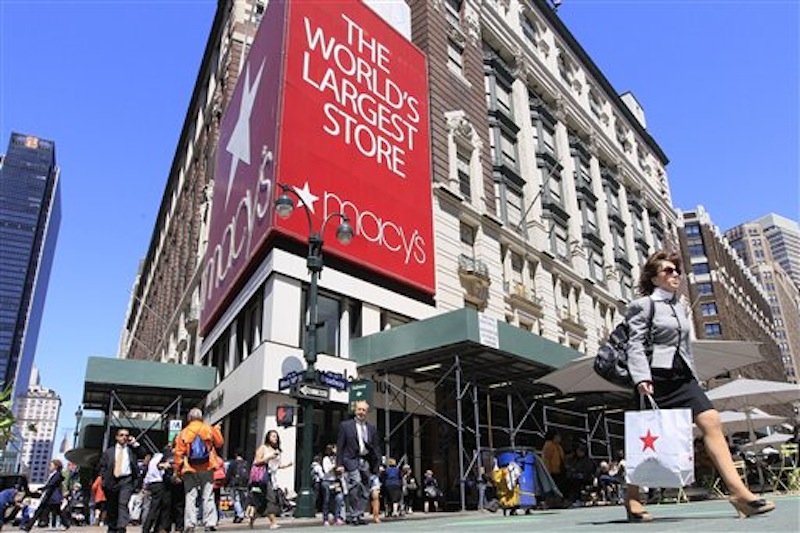 In this May 2011 photo, people carrying Macy's shopping bags walk past the Macy's flagship store, in New York. Macy's Inc., which runs Bloomingdale's and its namesake stores, said Thursday that February revenue at stores open at least a year climbed 4.6 percent to top analysts' estimates. (AP Photo/Mary Altaffer)