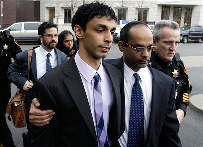 Dharun Ravi, center, is helped by his father, Ravi Pazhani, second right, as they leave court around in New Brunswick, N.J. on Friday, March 16, 2012. Defense attorney Philip Nettl follows, second left. Ravi, a former Rutgers University student accused of using a webcam to spy on his gay roommate's love life has been convicted of bias intimidation and invasion of privacy. A jury found that he used a webcam to spy on roommate Tyler Clementi. Within days, Clementi realized he had been watched and jumped to his death from New York's George Washington Bridge in September 2010. (AP Photo/Mel Evans)