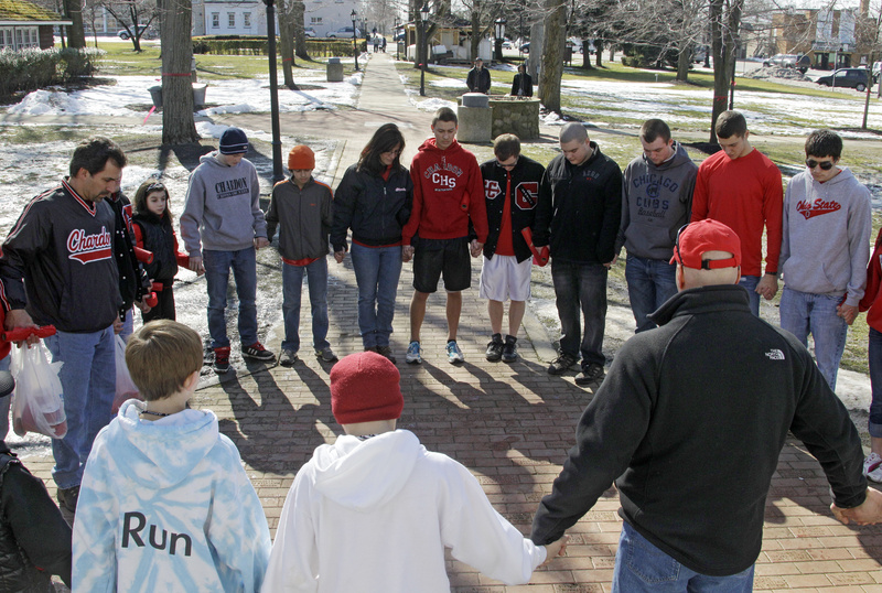A group of students and parents pray for victims of a school shooting Tuesday in Chardon, Ohio, that killed three people. Such tragedies cause schools to take any threat of violence seriously.