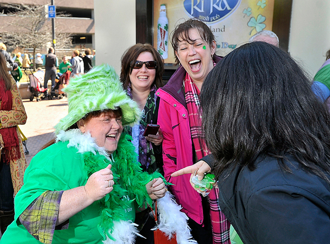 Liz Meserve of Portland entertains her friends with her outfit as she enjoys her first full day of celebrating St. Patrick's Day on Saturday, March 17, 2012. She is standing in line at Ri Ra's after having her first corned beef and cabbage breakfast at Brian Boru's.