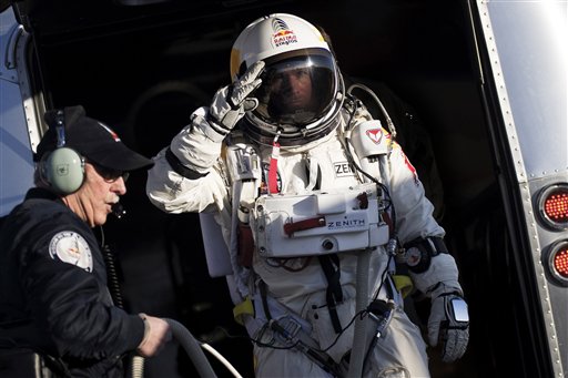 In this photo provided by Red Bull Stratos, Felix Baumgartner salutes as he prepares to board the capsule carried by a balloon during the first manned test flight for Red Bull Stratos in Roswell, N.M., on Thursday. Baumgartner is more than halfway toward his goal of setting a world record for the highest jump.