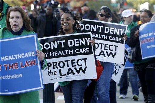 Supporters of the health care reform law signed by President Obama gather in front of the Supreme Court in Washington today, as the court begins three days of arguments on health care.