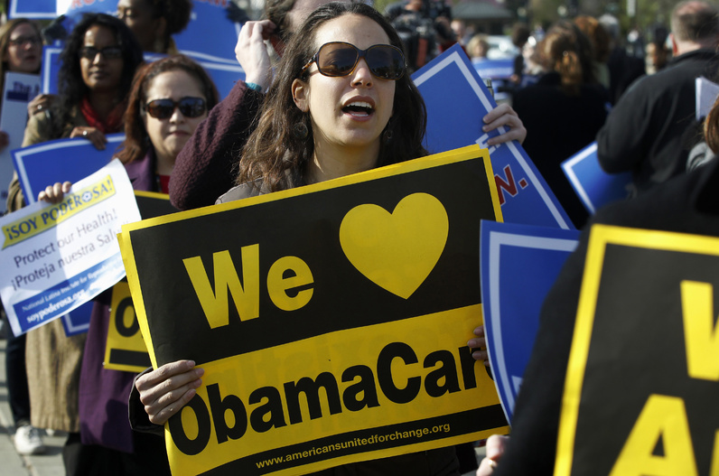 Supporters of health care reform demonstrate in front of the Supreme Court in Washington on Wednesday.