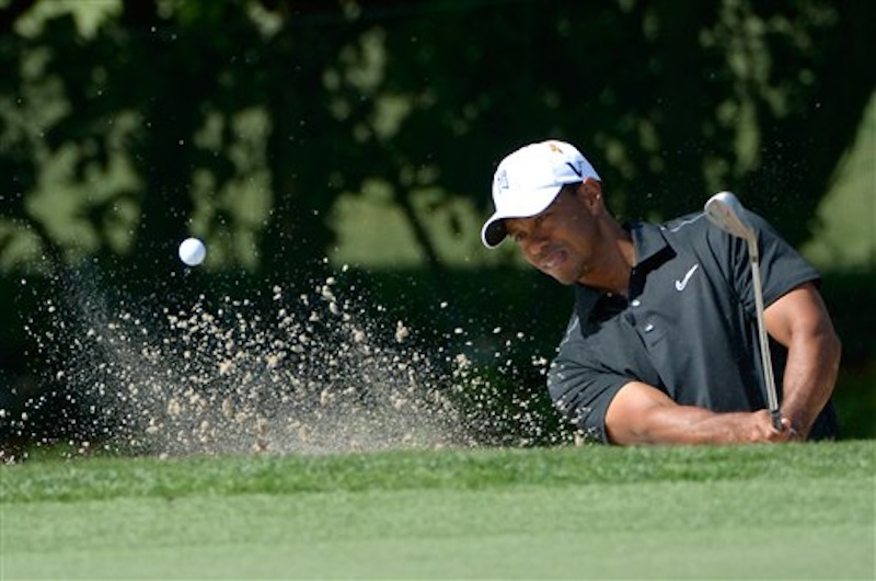 Tiger Woods hits out of a green-side bunker on the first hole during the first round of the Arnold Palmer Invitational golf tournament at Bay Hill in Orlando, Fla. on Thursday, March 22, 2012.(AP Photo/Phelan M. Ebenhack)