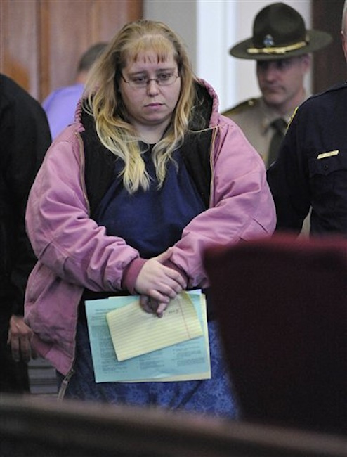 Patricia Prue is led into court Wednesday in St. Johnsbury, Vt.