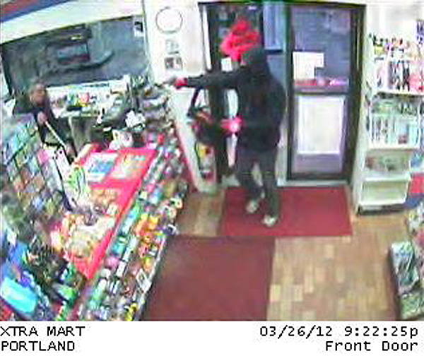 A surveillance camera captured this image of the XtraMart robbery in progress.