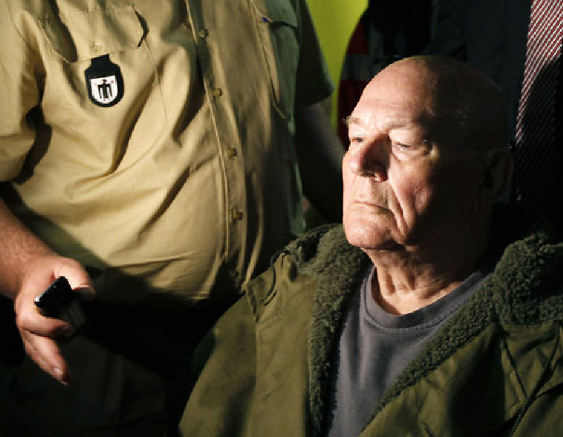 John Demjanjuk leaves a courtroom Thursday in Munich, Germany. He was sentenced to five years in prison on 28,060 counts of accessory to murder for the number of people who were killed in the Sobibor death camp. He was released pending an appeal of his conviction.
