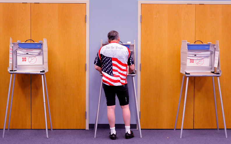 Robert Jewell who is a ''bicycle commuter'' votes in the Illinois primary election at the Bourbonnais Municipal Center in Bourgonnais, Ill., this morning.