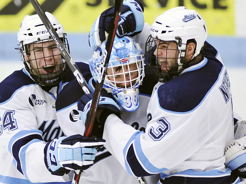 Maine goalie Dan Sullivan, center celebrates with Ryan Hegarty (44) and Mark Nemec (3) after defeating Merrimack in a Hockey East tournament quarterfinal Sunday in Orono.