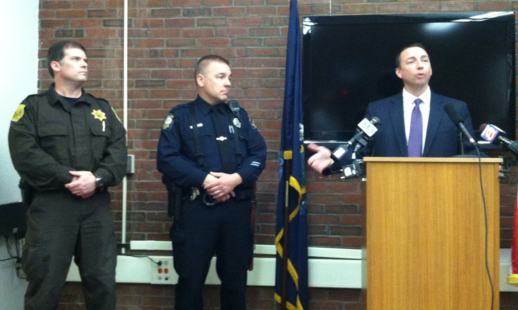 Sheriff's Deputy Richard Kimball, left, and Portland Officer Dan Rose, center, are praised by Portland Police Chief Michael Sauschuck during a news conference on Wednesday.