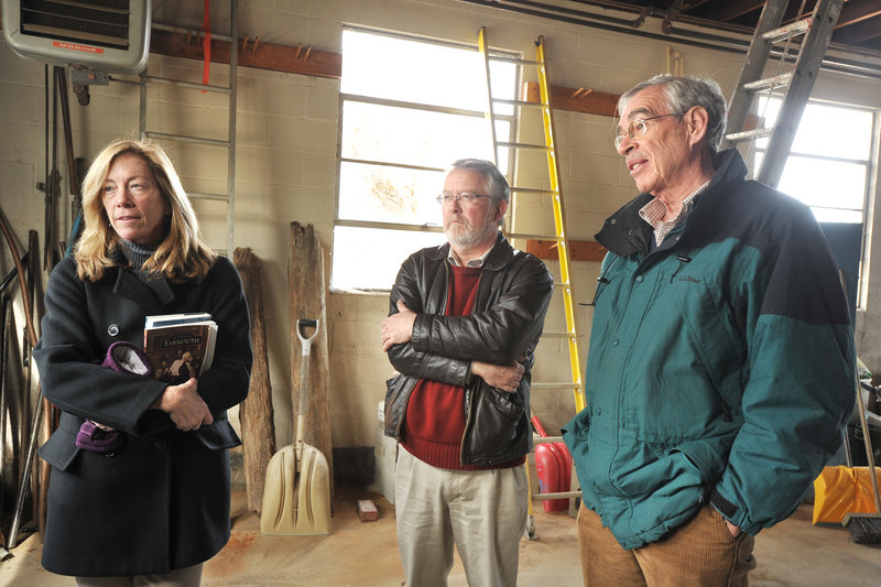 Yarmouth Historical Society officials Amy Thompson, Michael Chaney and John Palmer, standing this week in the former town water district building on East Elm Street, discuss plans for developing a new history center there.