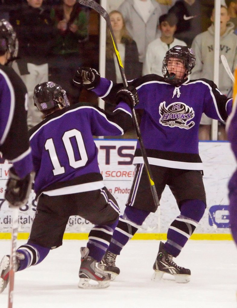 Peter Lajeunesse, left, and Nick Deveau of Marshwood-Traip Academy celebrate Lajeunesse’s first-period goal Wednesday night in the 5-3 victory against Cheverus in a Western Class A boys’ hockey quarterfinal at the Portland Ice Arena.
