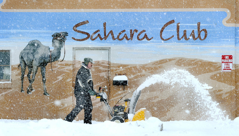 Robert Haney of Portland seems to be blowing dunes of snow in front of the Sahara Club along Washington Avenue on Thursday.
