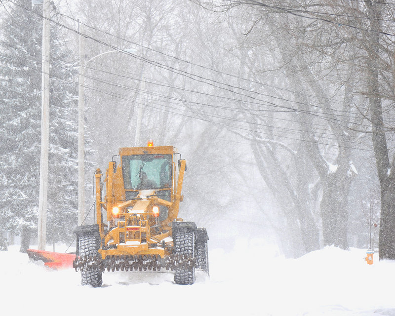 A snowplow driver makes his way up Gleckler Road in Portland during Thursday’s snowstorm.