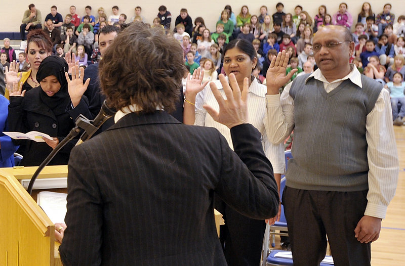 Daxa and Chandrakant Patel, right, from India, were among those who became United States citizens at a naturalization ceremony at Falmouth Elementary School on Friday. They Scarborough couple came to the U.S. to be closer to family.